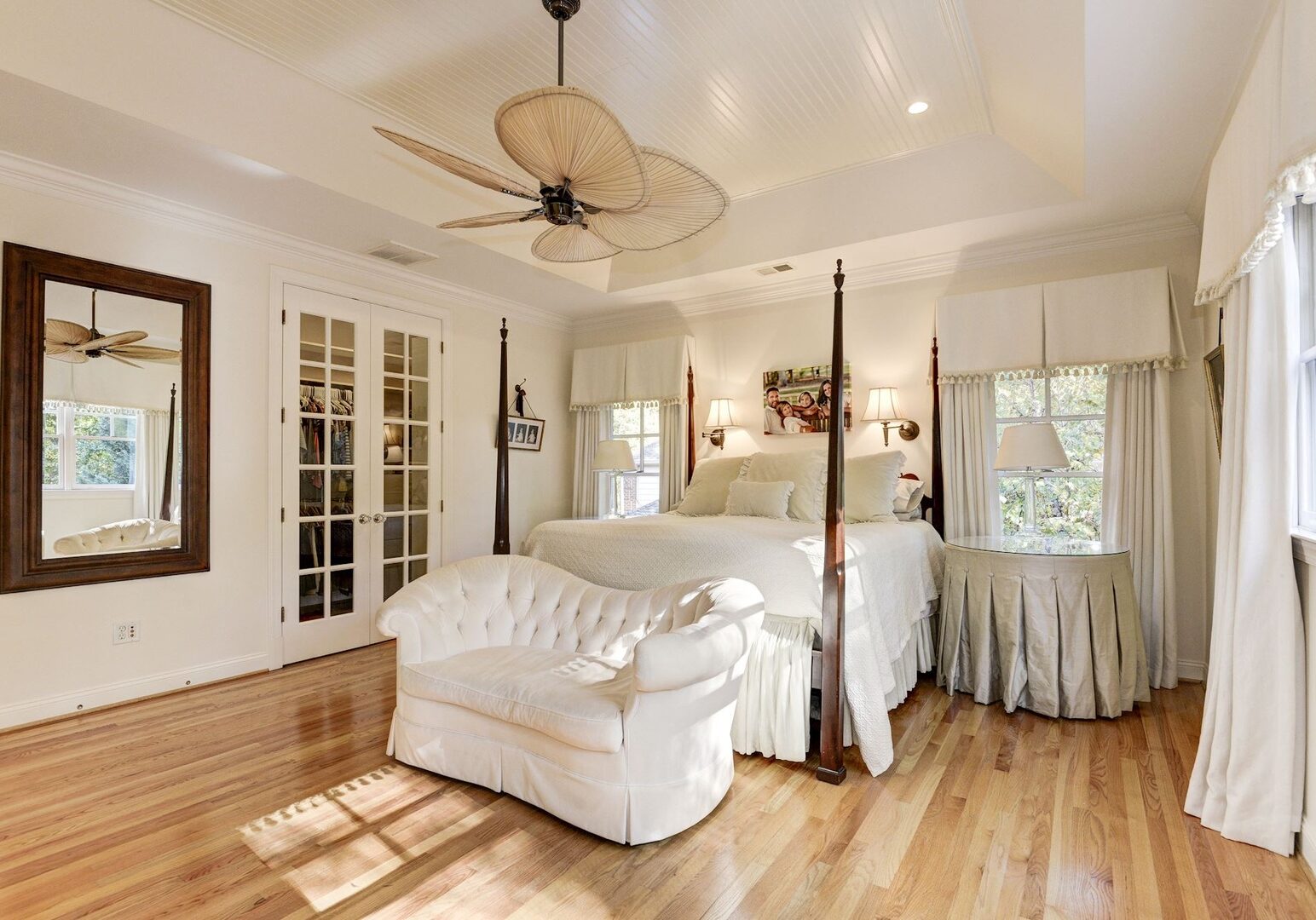 A clean and predominantly white bedroom